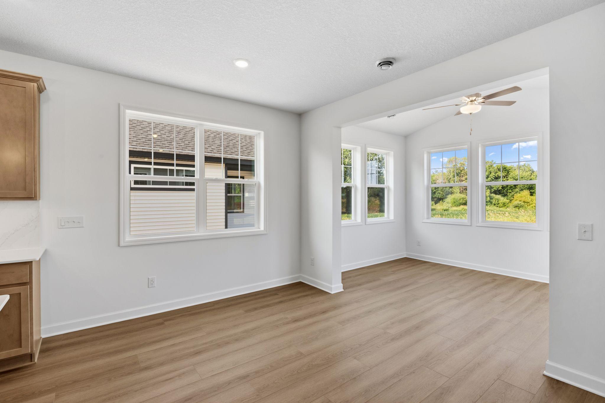 The dining room is situated among the open floorplan, promoting seamless flow between rooms.