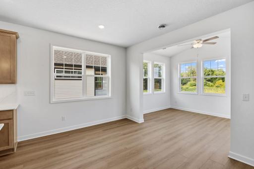 The dining room is situated among the open floorplan, promoting seamless flow between rooms.