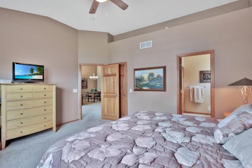Primary bedroom with top ledge for decorating or lighting. Spacious private closet with custom finishes (shelving and clothes storage).