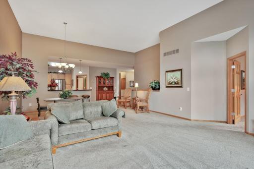 Another view of the living and dining area with door to the far right to the Primary main floor bedroom suite.