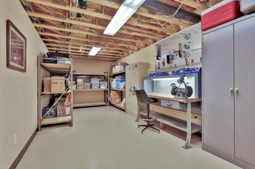 Lower level work shop and storage room. Work bench, cabinets and heavy duty shelving could be available for sale.