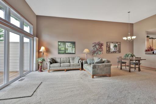 Southern exposure living room for exceptional seasonal sun. 12' side patio access with transom windows above.