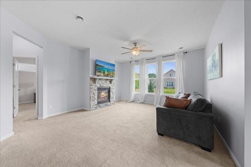 Living room with gas fireplace and abundant natural light