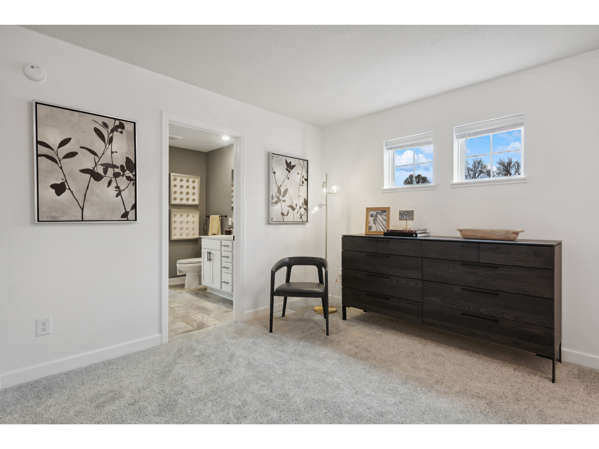(Photo of a decorated model, actual homes finishes will vary) Spacious, imaginative and modern would best describe the owner's suite.