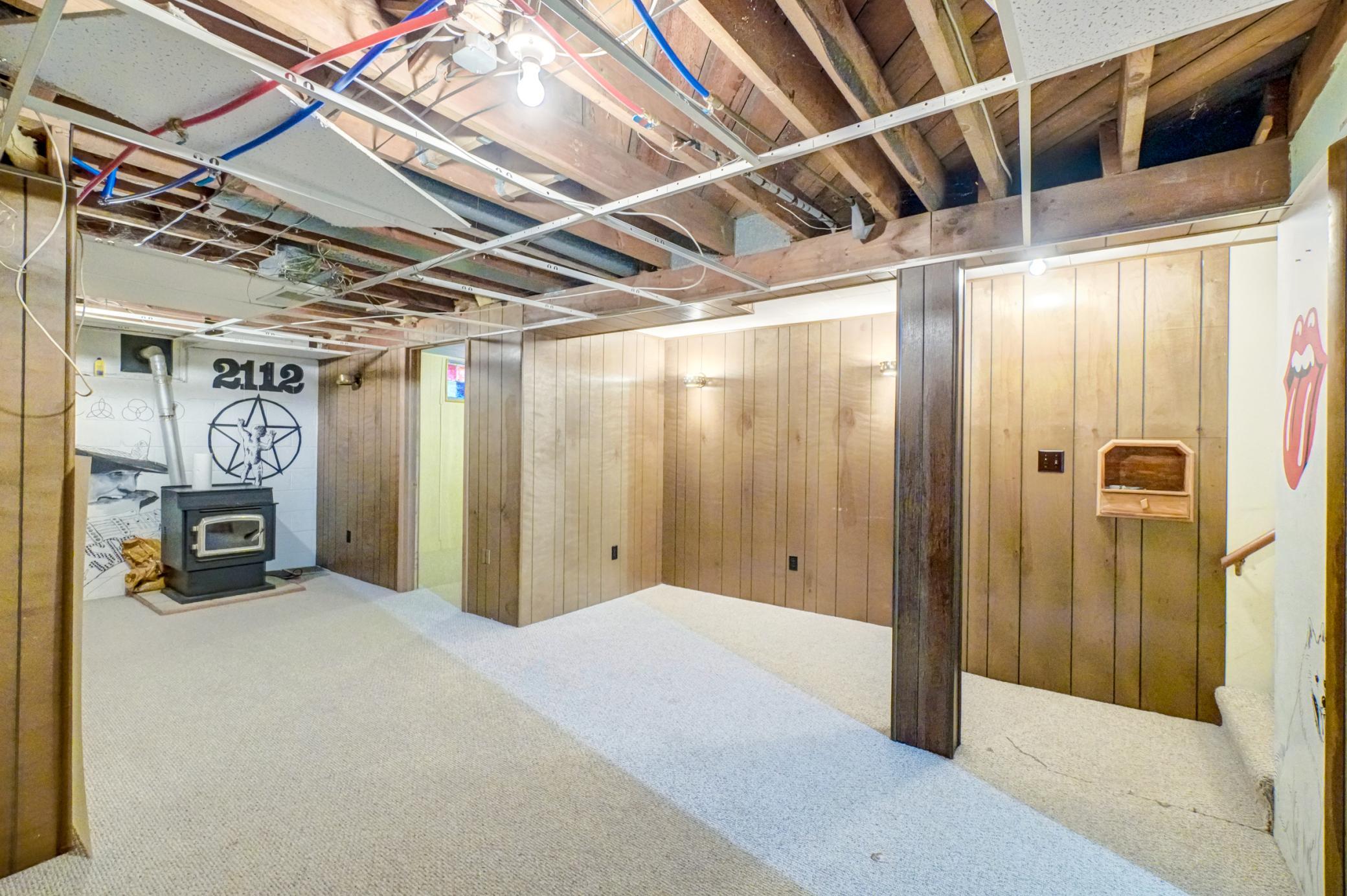The lower level offers a large family room with a pellet-burning stove and plenty of storage and hobby space, providing flexibility for everyday living.