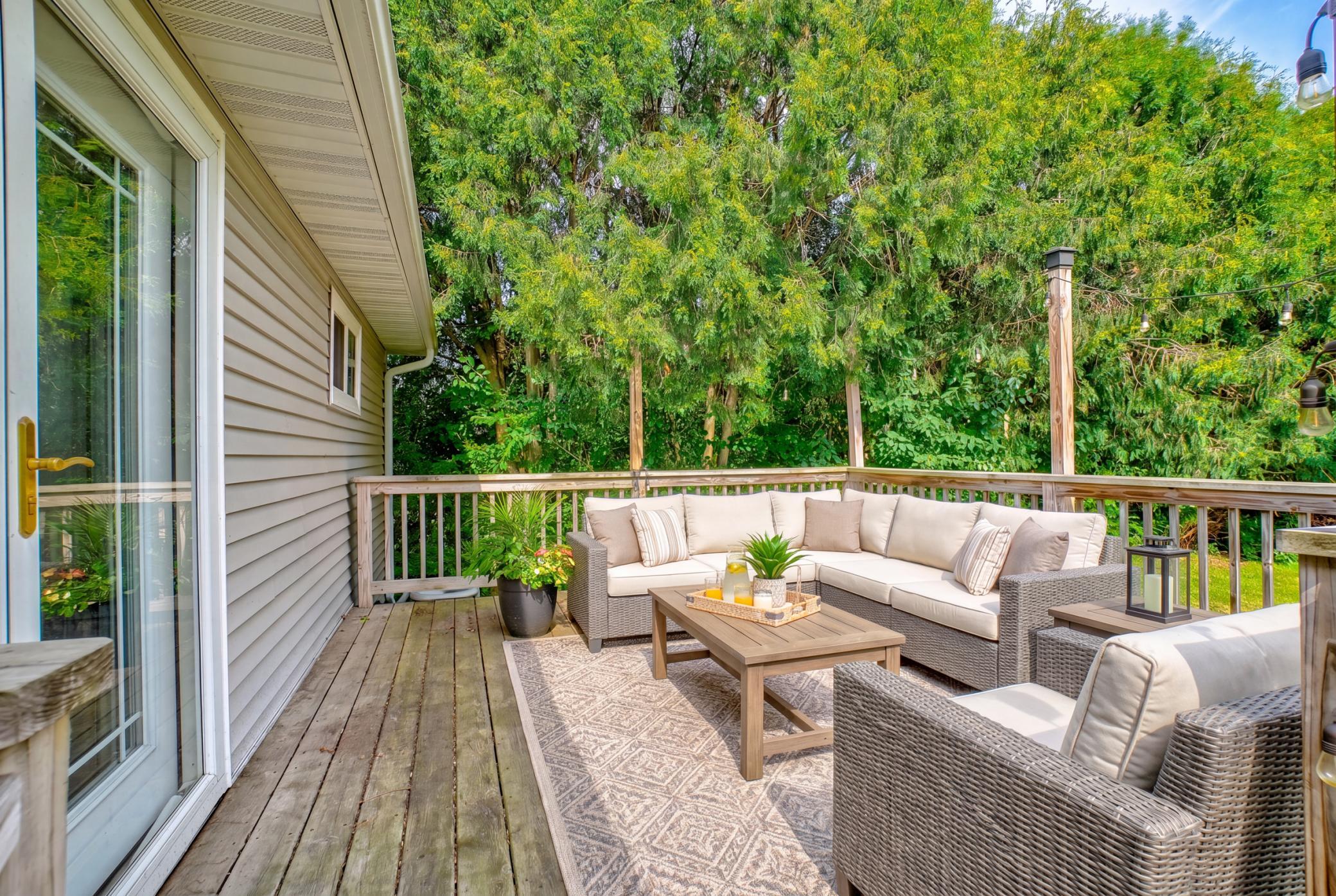 Outside, enjoy a walkout deck leading to the private backyard with ample room to enjoy the outdoors. (virtually staged)