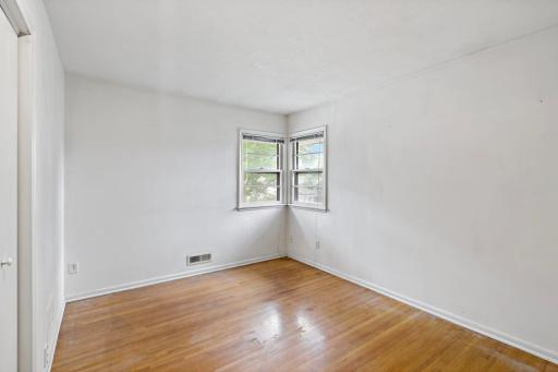 Three bedrooms, all with wood floors, are located in a separate area of the home that can be closed off with a door for added privacy.