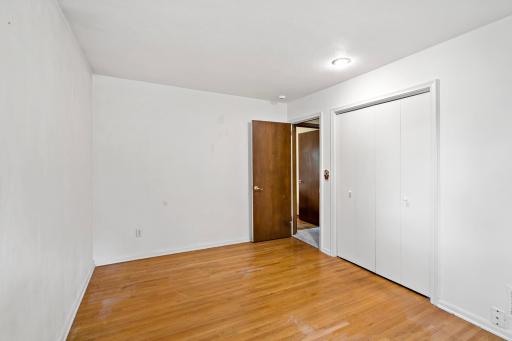 Three bedrooms, all with wood floors, are located in a separate area of the home that can be closed off with a door for added privacy.