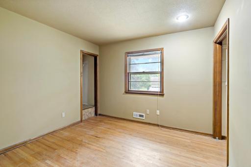 Three bedrooms, all with wood floors, are located in a separate area of the home that can be closed off with a door for added privacy.