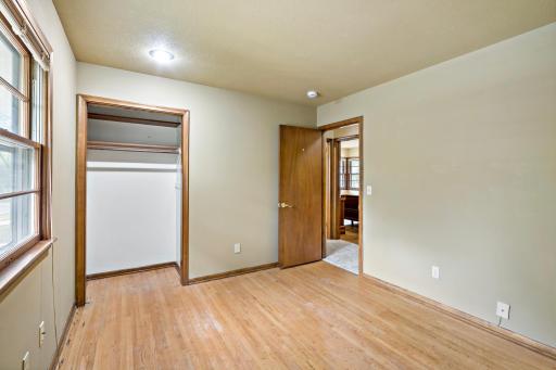 Three bedrooms, all with wood floors, are located in a separate area of the home that can be closed off with a door for added privacy.