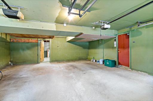 Spacious two-car garage with additional storage space in the back, perfect for a workshop, hobby area, or extra storage for all your needs.