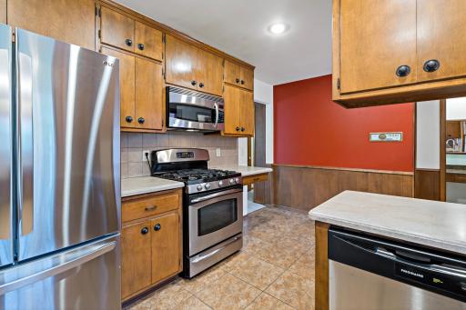 Eat-in kitchen featuring stainless steel appliances and a comfortable dining area, perfect for casual meals and everyday living.