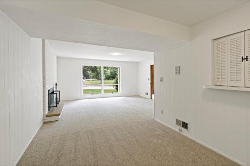 Bright lower-level entertaining space with large windows, a cozy fireplace, and privacy from the main floor—perfect for relaxing or gathering with guests.