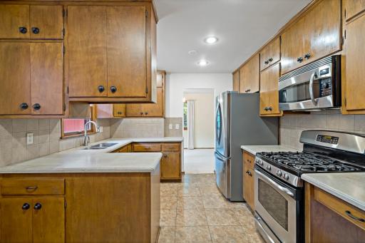 Eat-in kitchen featuring stainless steel appliances and a comfortable dining area, perfect for casual meals and everyday living.