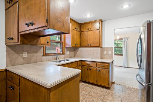 Eat-in kitchen featuring stainless steel appliances and a comfortable dining area, perfect for casual meals and everyday living.