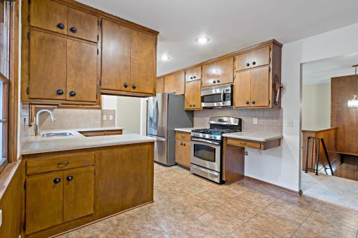 Eat-in kitchen featuring stainless steel appliances and a comfortable dining area, perfect for casual meals and everyday living.