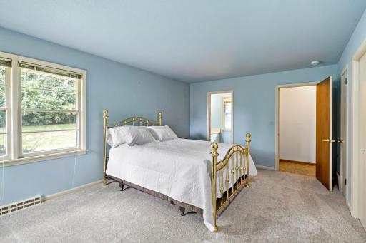 Spacious primary bedroom tucked away from the main living areas, complete with an attached private bathroom for added comfort and convenience.