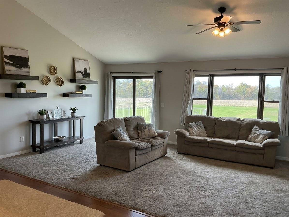 Main level living room with walkout to upper level deck