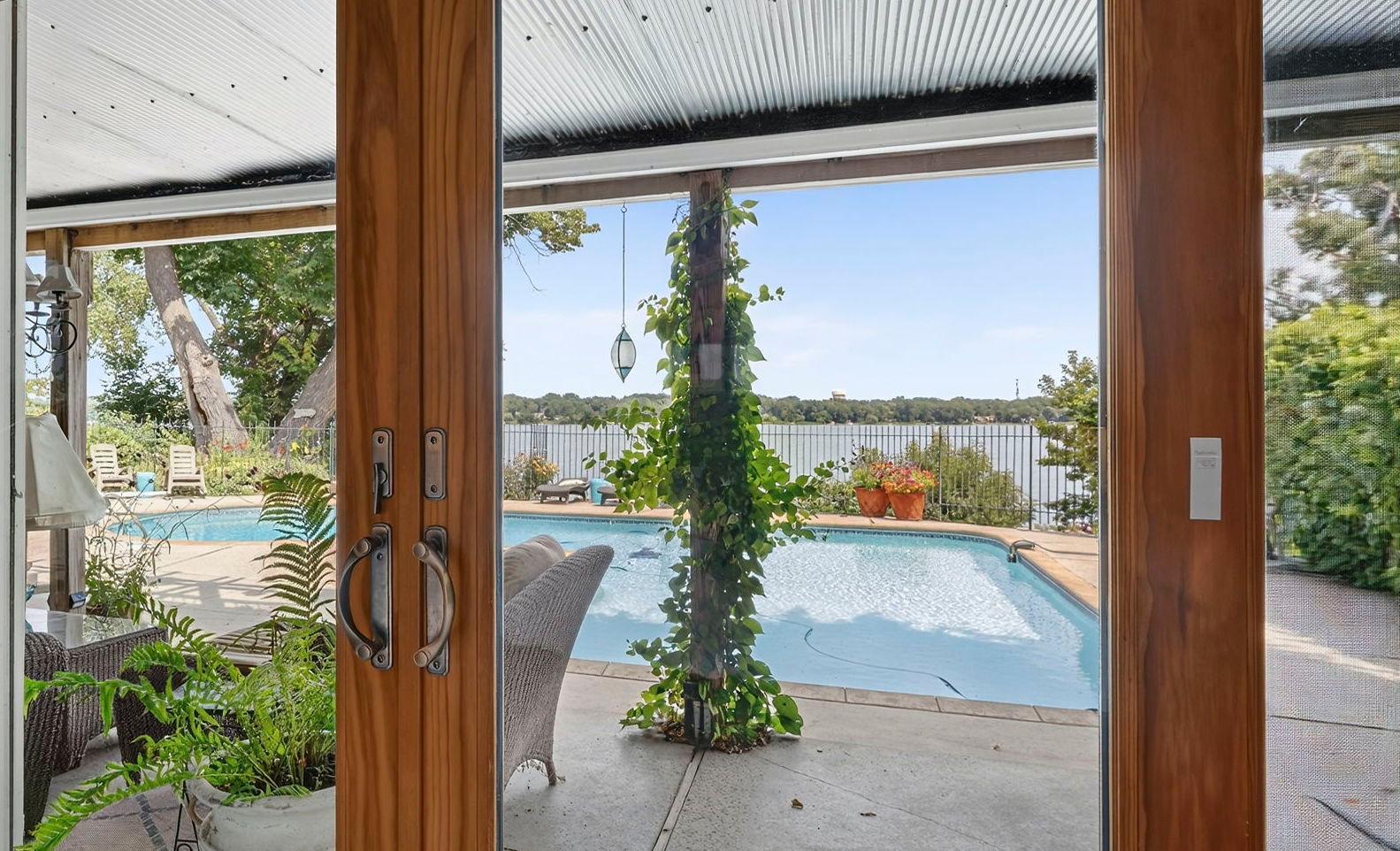 Primary suite has view to pool and lake.jpg