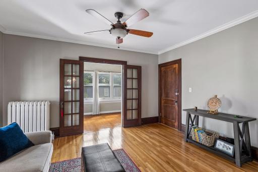 French doors open to an inviting, cheery sunroom.