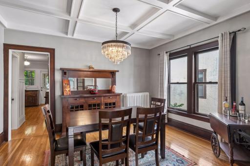 The large dining room in the center of the home features a boxed & beamed ceiling and a classic built-in buffet.