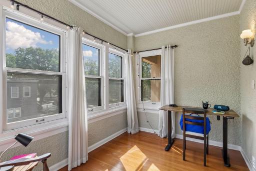 This sunroom has windows facing north, south & east and is ideal for a home office or a getaway reading spot.