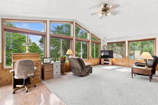 East wing of the home was added in 1998 and includes the family room, primary bedroom, and full bathroom, as well as access to the rear deck and lakeside.