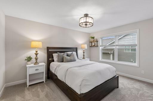 Designed for comfort and privacy, the primary suite offers generous space, a walk-in closet, and a stylish ensuite bath with a tiled walk-in shower.