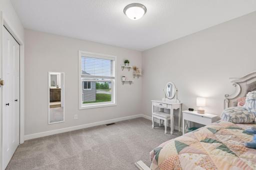 A third spacious upper-level bedroom with plenty of natural light, ready to fit your family's needs.