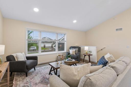 Vaulted ceilings, large windows, and an open layout create a bright, inviting living room that's perfect for relaxing, entertaining, or spending time with family.