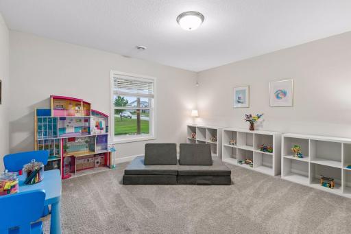 With generous space and natural light, this lower-level bedroom is currently used as a playroom, creating the perfect spot for fun today and a bedroom tomorrow.