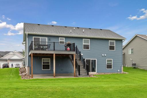 Enjoy outdoor living from day one with a maintenance-free deck and stairs to the backyard, a concrete patio, professional landscaping, irrigation system, gutters, and a walkout lower level. Everything is already done for you!
