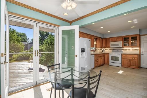 Open french doors to deck and backyard.