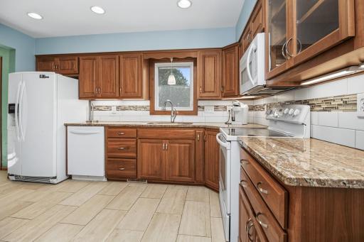 Cherry cabinets, granite countertops, tile backsplash and LVT flooring. Moveable island too.