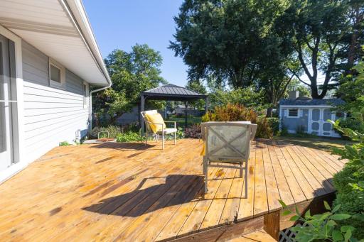 Deck overlooks backyard.