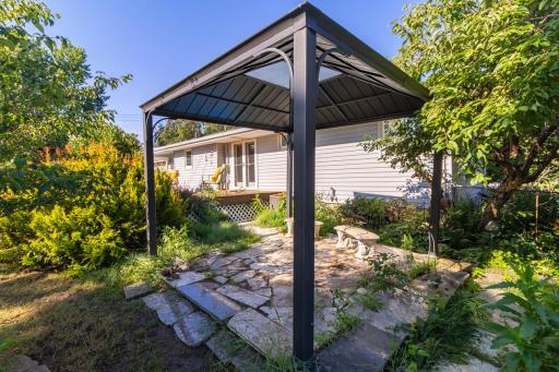 Patio and pergula in backyard.