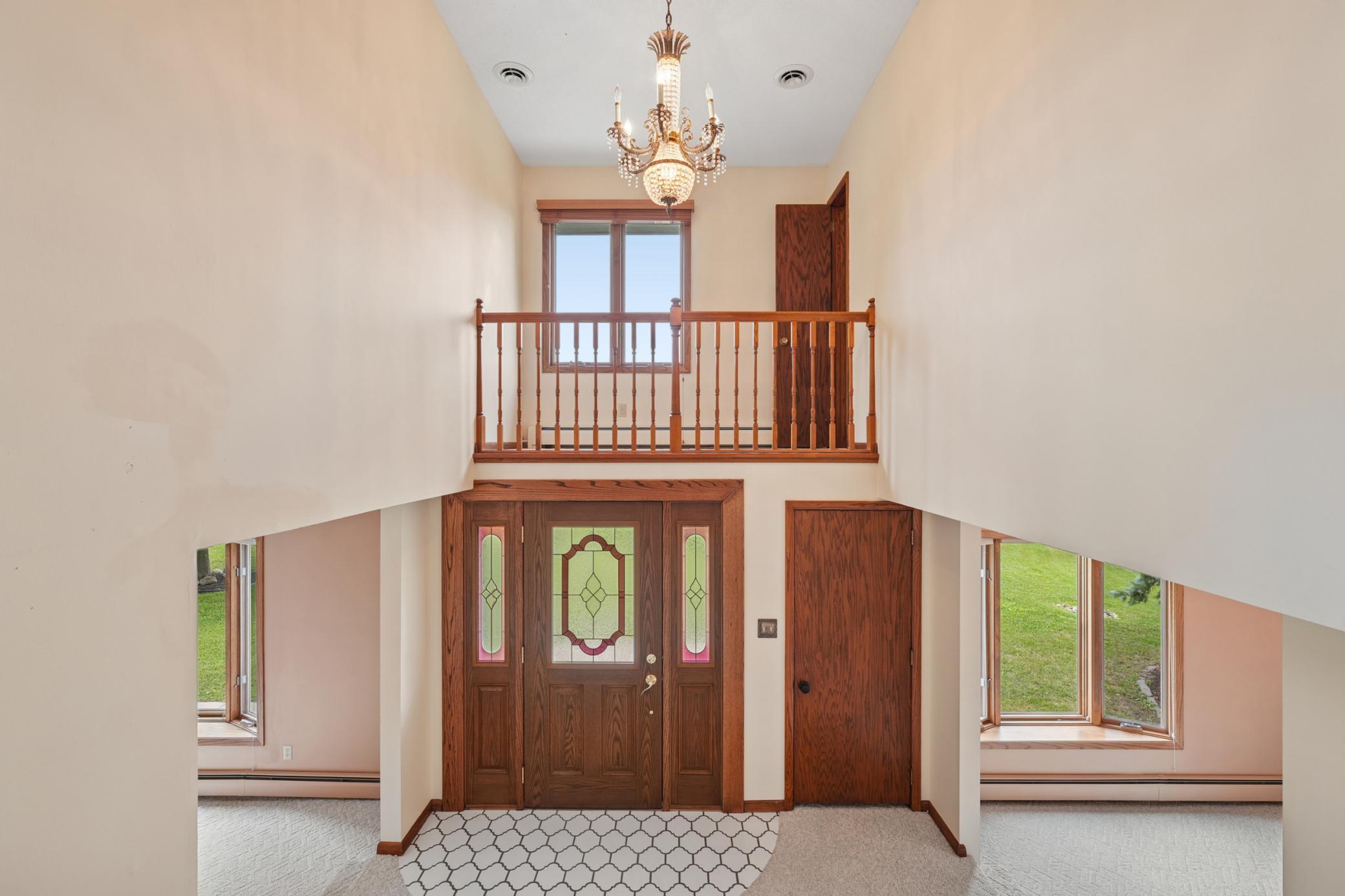 Impressive Entryway with Expansive Staircase