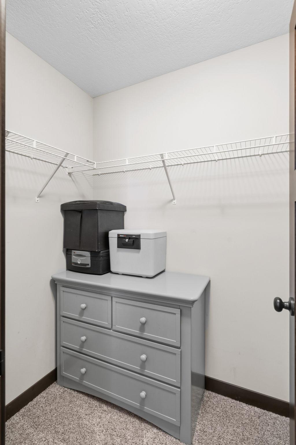 Walk-in closet providing convenient storage for the secondary bedroom.