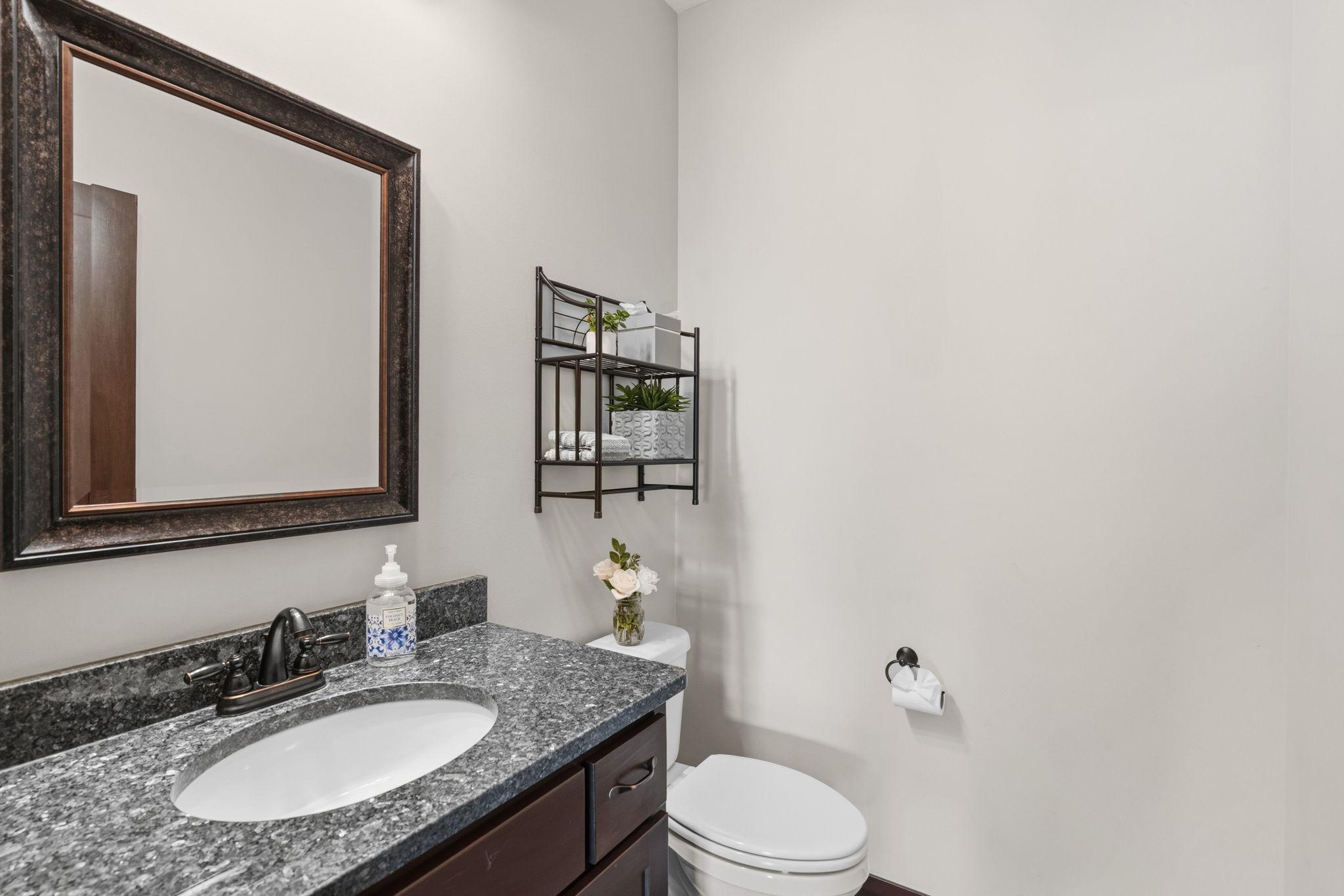Convenient main-level powder room with granite vanity.