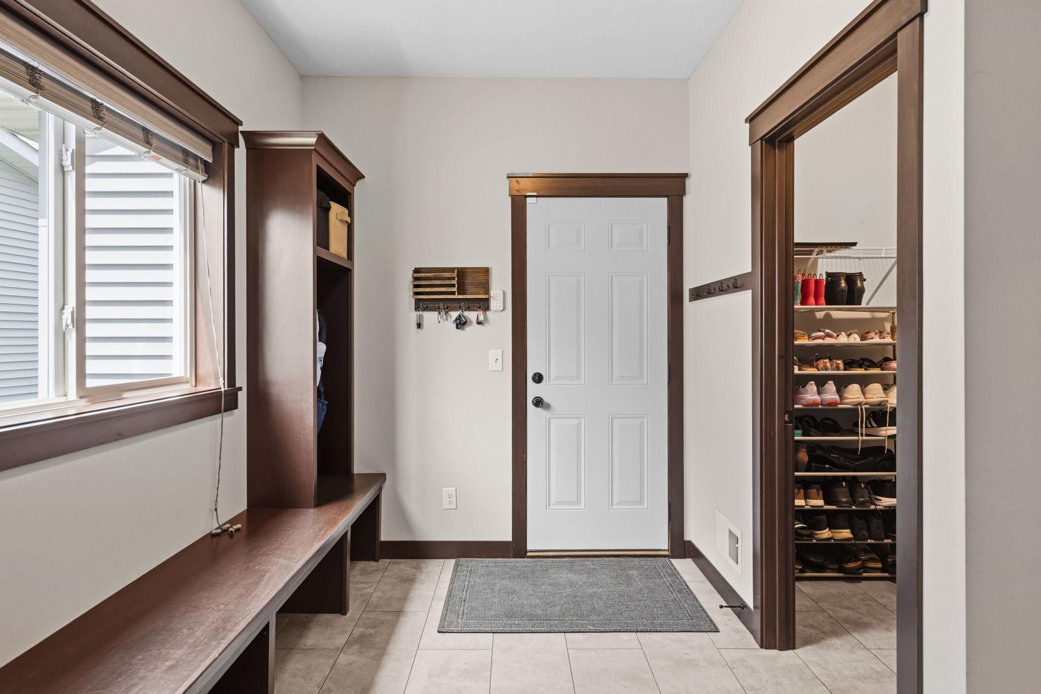 Welcoming garage entry with built-in bench and convenient everyday storage with a large walk-in closet.