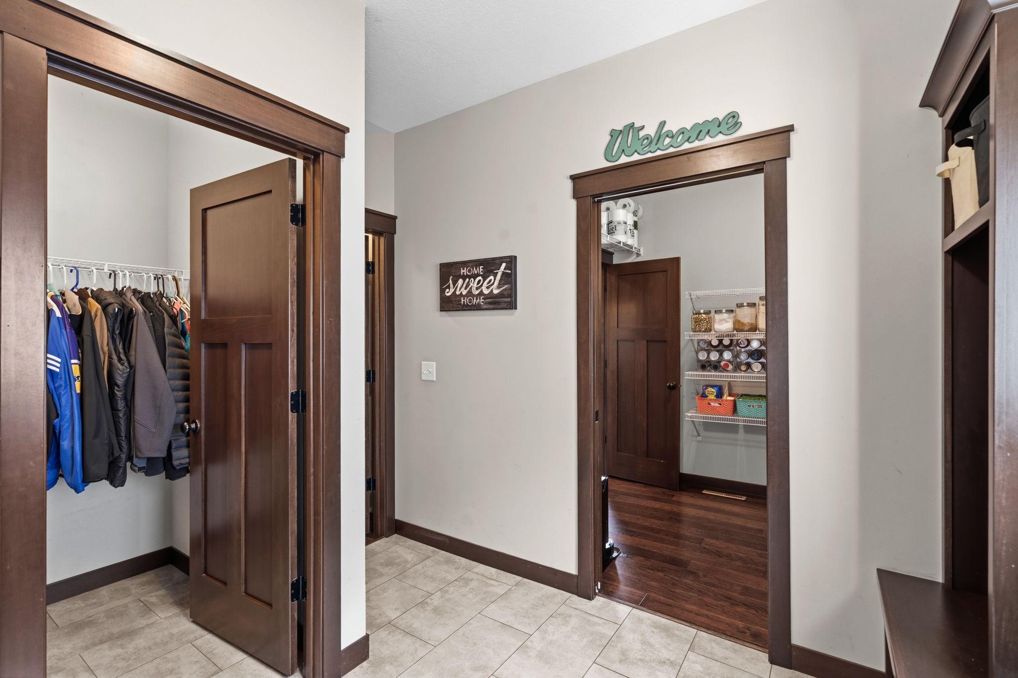 Functional mudroom connecting the garage, pantry, kitchen, and main living areas.
