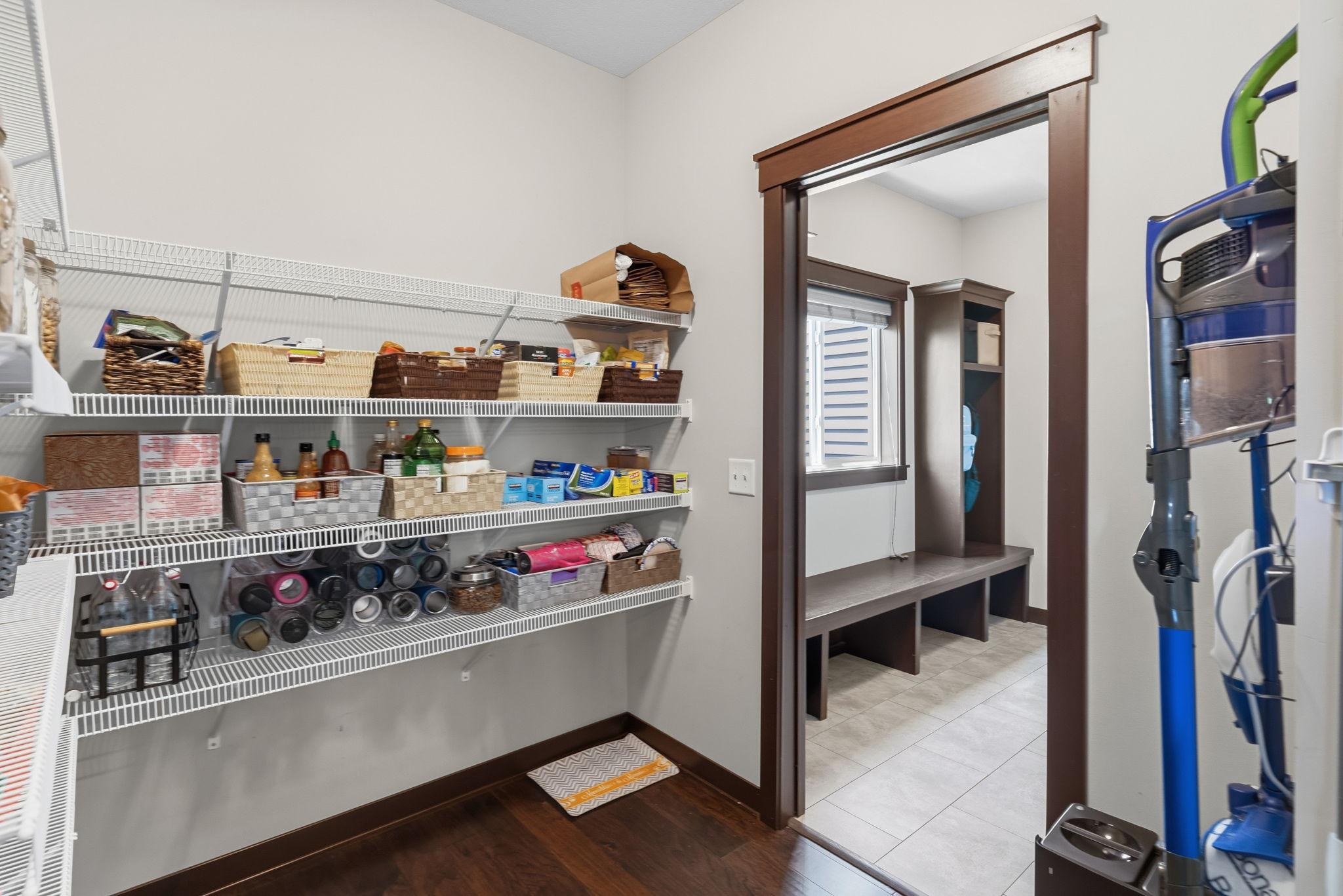 Spacious walk-in pantry offering exceptional storage and organization.