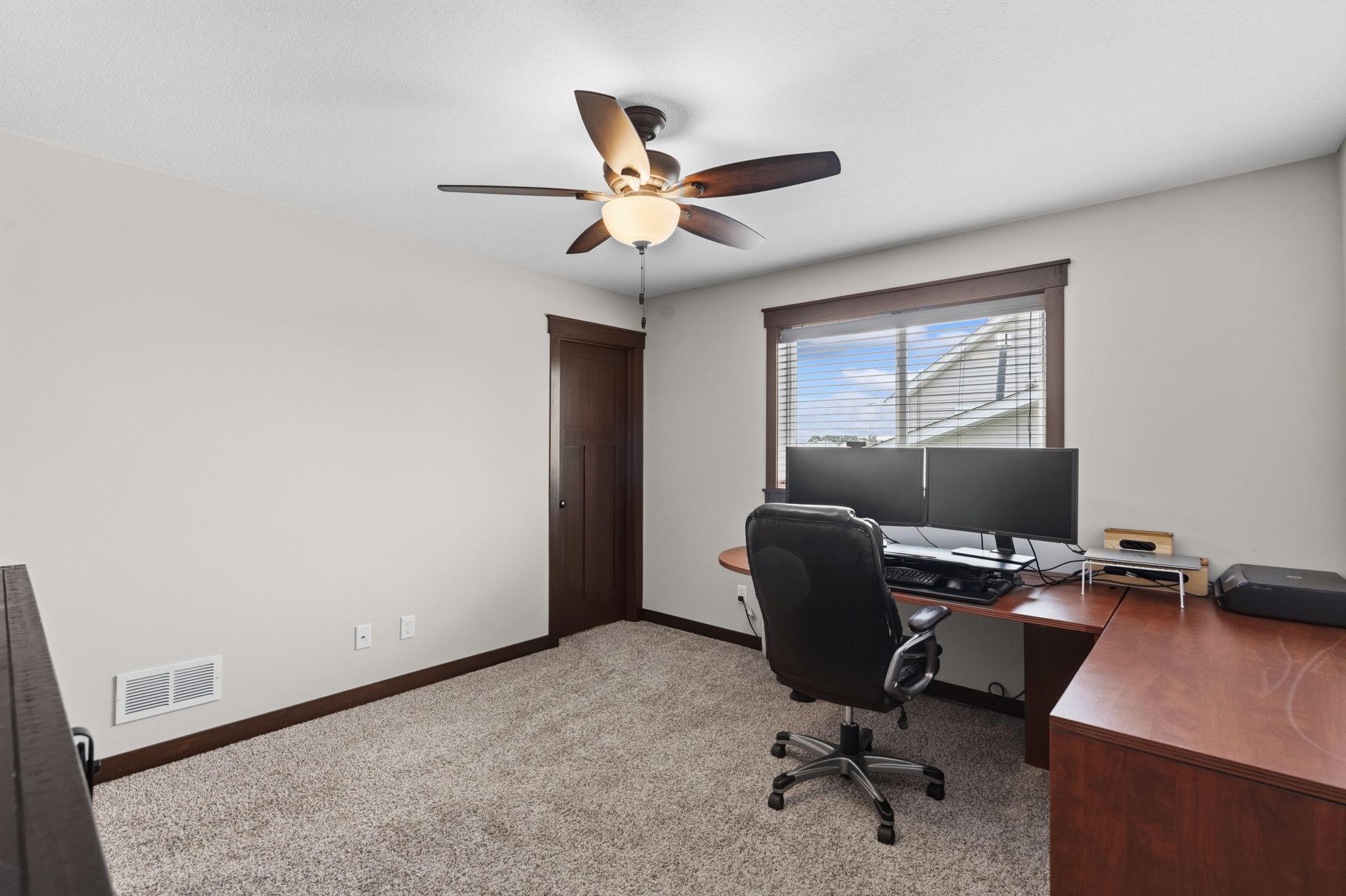Versatile secondary bedroom with ample closet space and natural light.