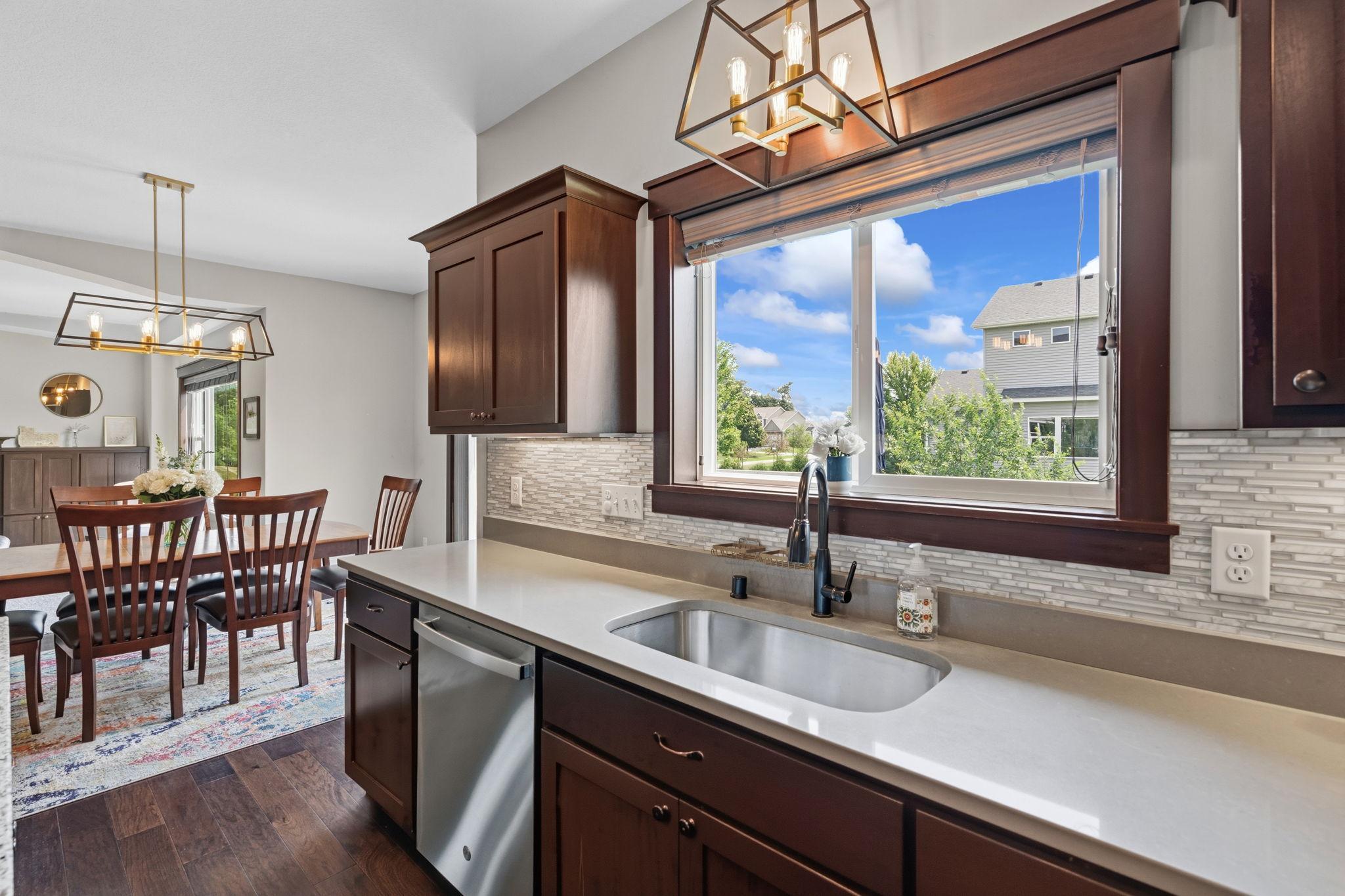 Kitchen sink overlooking the backyard with abundant natural light.