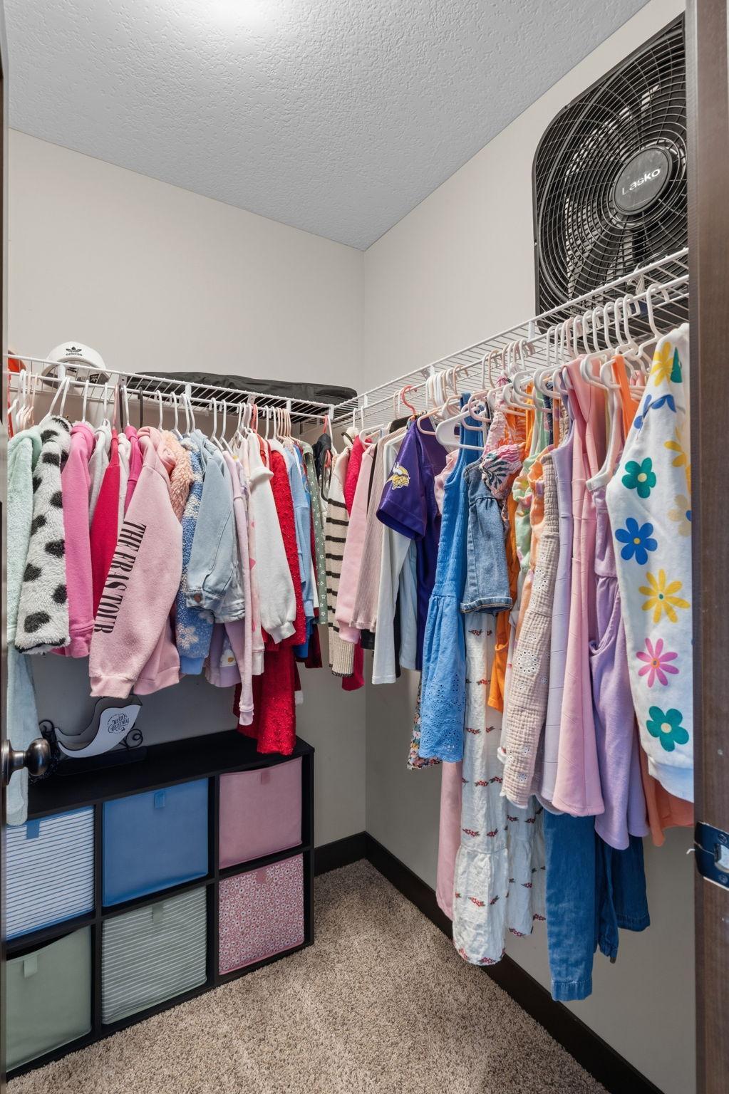 Secondary bedroom walk-in closet providing abundant storage and organization.