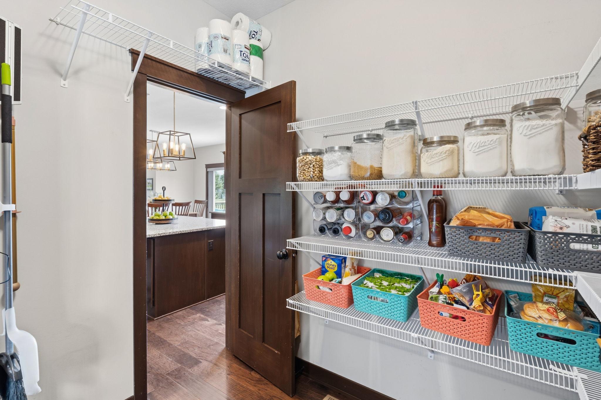 Convenient walk-in pantry with direct access to the mudroom and kitchen.