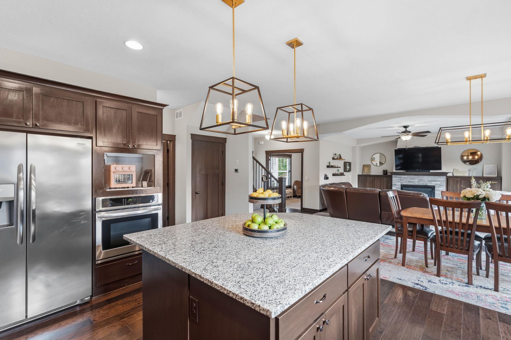Open-concept kitchen with large center island overlooking the dining and living areas.