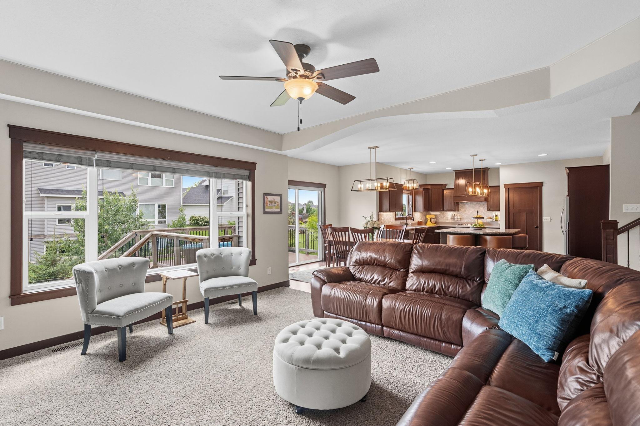 Bright, open-concept main level connecting the living room, dining area, and kitchen.