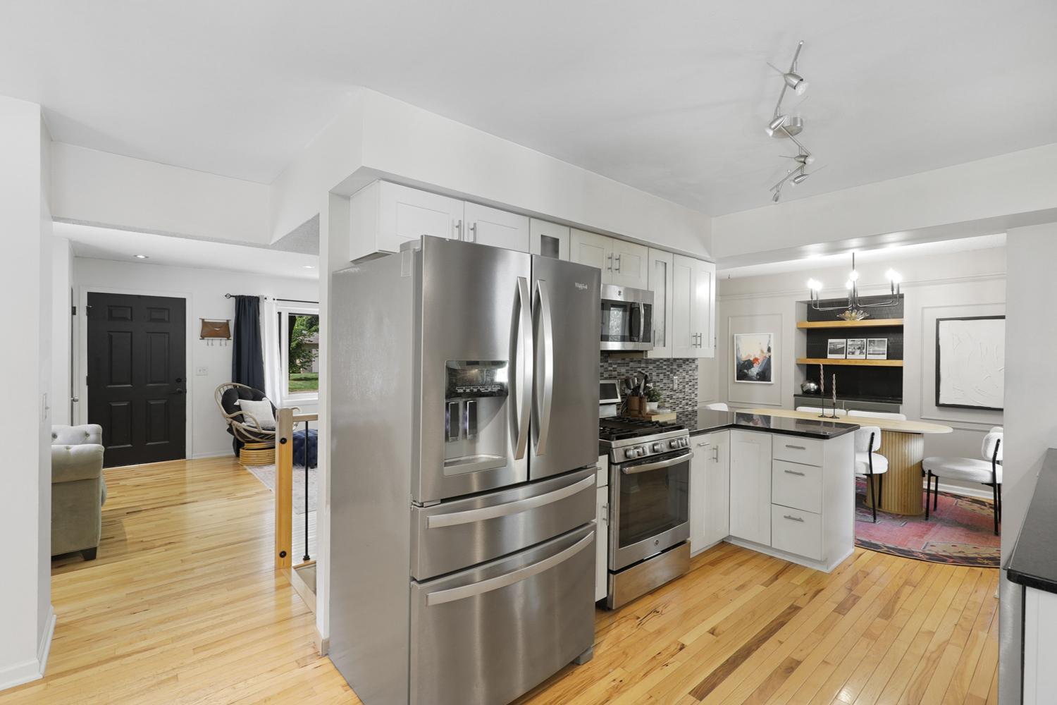 The updated kitchen is the centerpiece of the home featuring newer stainless steel appliances