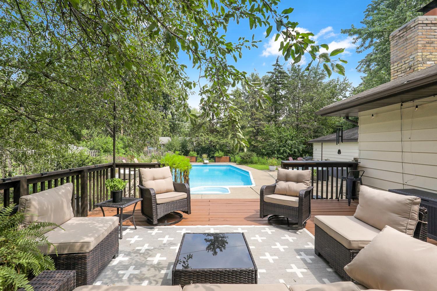 Stepping outside, the large well maintained deck overlooks the pool - this yard is an entertainer's dream!